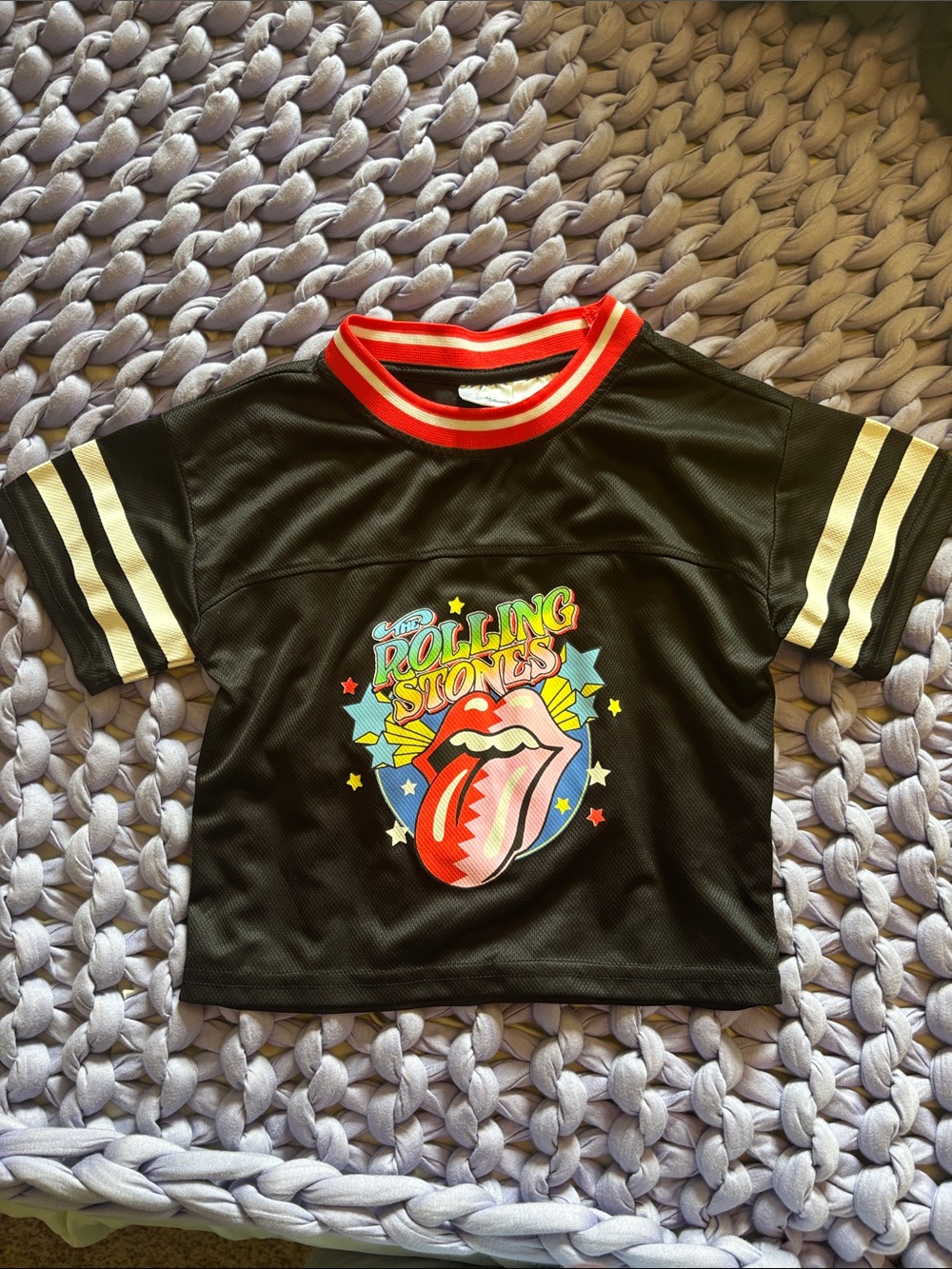the Rolling Stones Black Kids Tee with Red Collar and Cream Sleeve Stripes